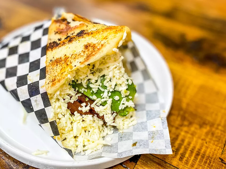 Arepas Venesuela: shredded chicken, shredded meat, pork, avocado and cheese in a white corn cake - HANK VAUGHN