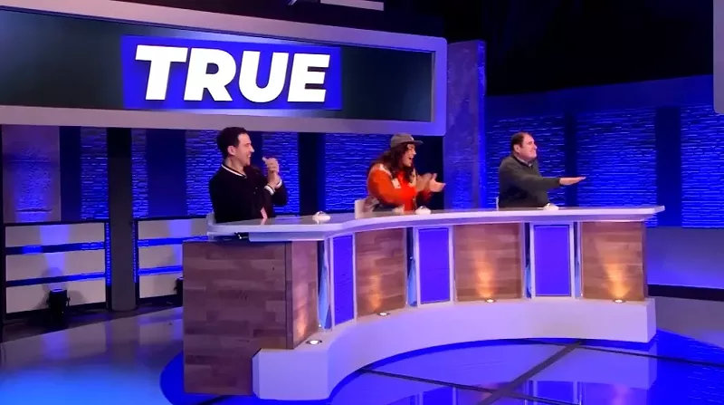 Image: Comedian Sabrina Jalees' (middle) team consisting of Santino Fontana (left) and Richard Kind trick their opposing team with a true story on The CW series Would I Lie to You?, an American version of the long running British panel show.