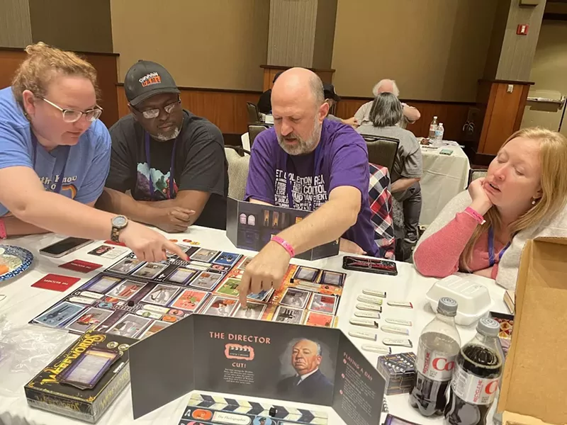 Image: A group of "tenants" trying to figure out what's going on in the apartments during a round of Rear Window, a Funko board game based on the Alfred Hitchcock movie of the same name.