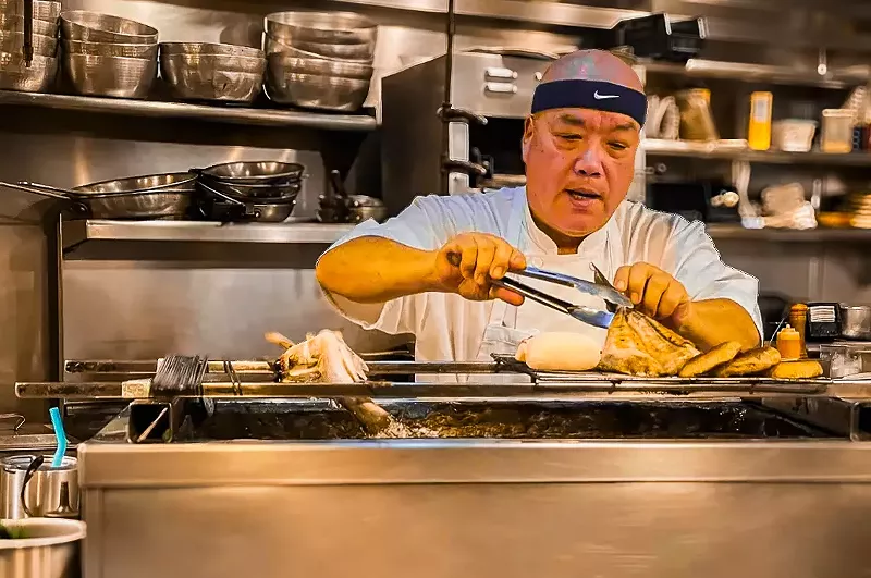 Image: Tei Tei's owner Katsutoshi Sakamoto working his magic on the robata grill.