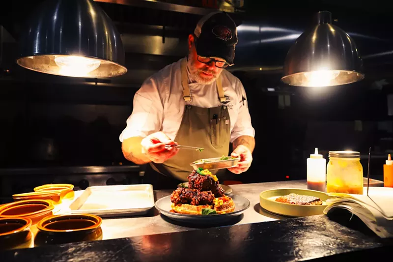 Image: Chef Lance McWhorter plates dishes at Heritage East.