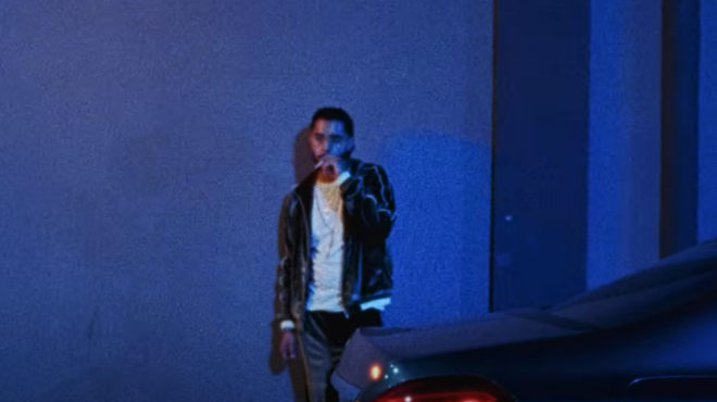 Man smoking in front of car