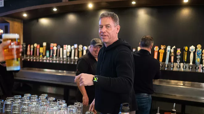 Troy Aikman tending bar at The Katy Trail Ice House