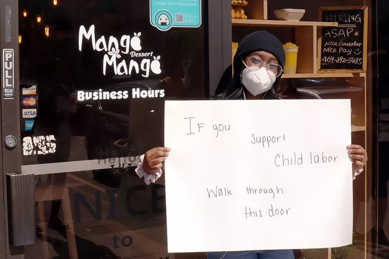 Image: Former Mango Mango employee Qui Perry protests outside of the store.