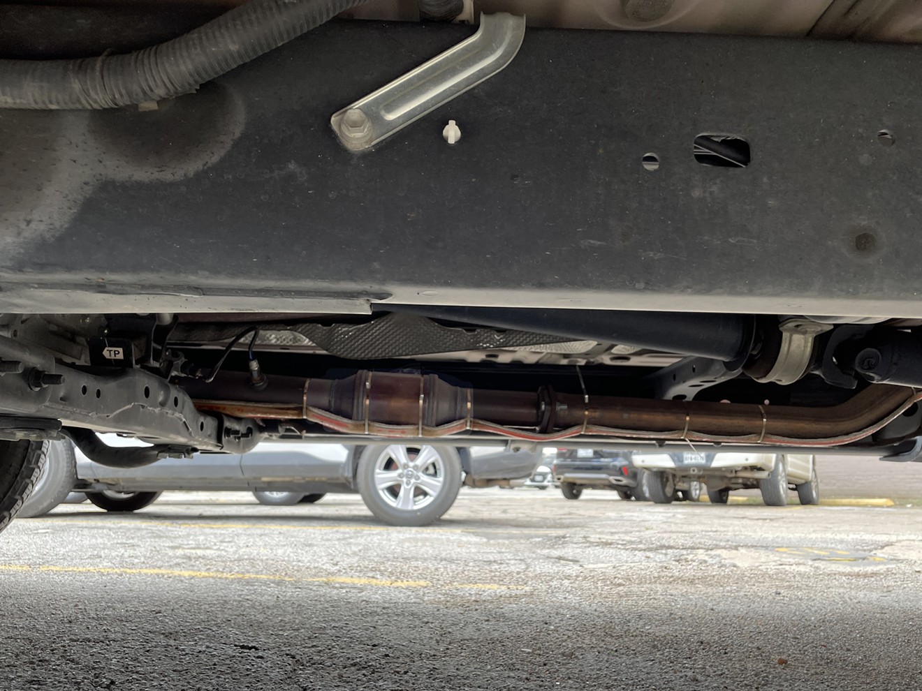 The Observer editor's new catalytic converter (highlighted) with its added 'cat strap,' a ribbon of kevlar and wires intended to discourage thieves by making them work a little harder.