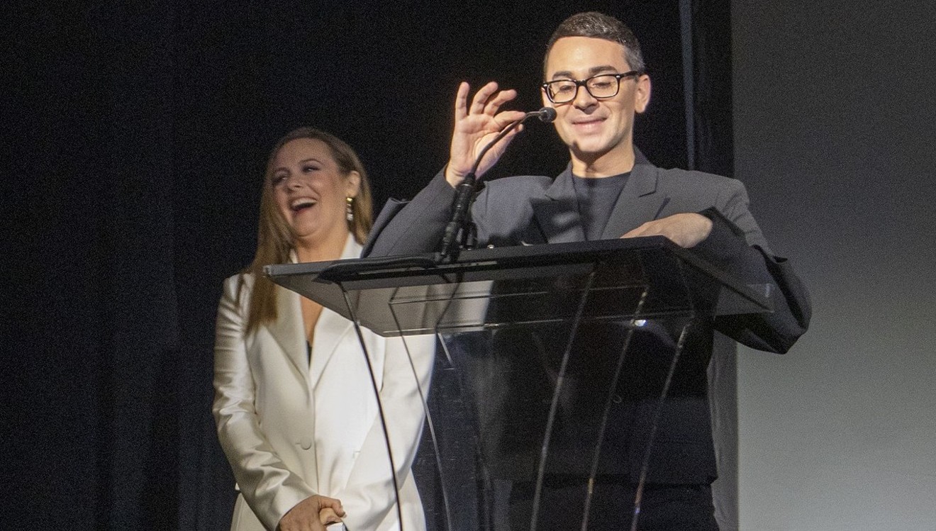 Christian Siriano receives a design award from close friend Alicia Silverstone.