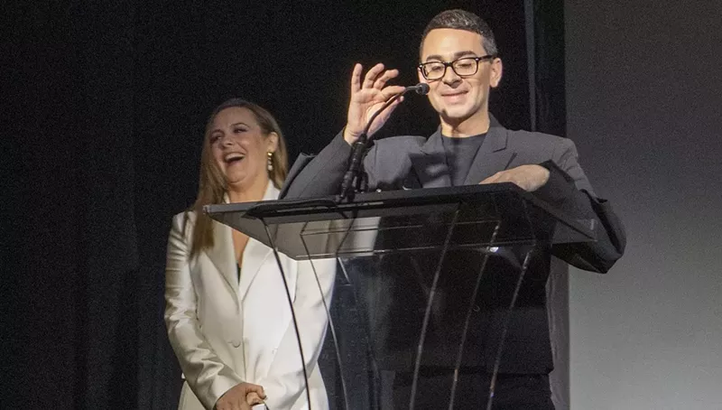 Image: Christian Siriano receives a design award from close friend Alicia Silverstone.