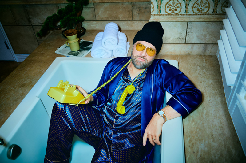 Image: Man in tub with yellow phone