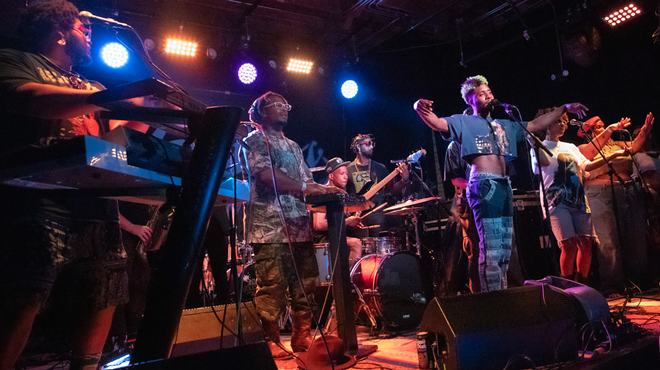 The band is performing on stage