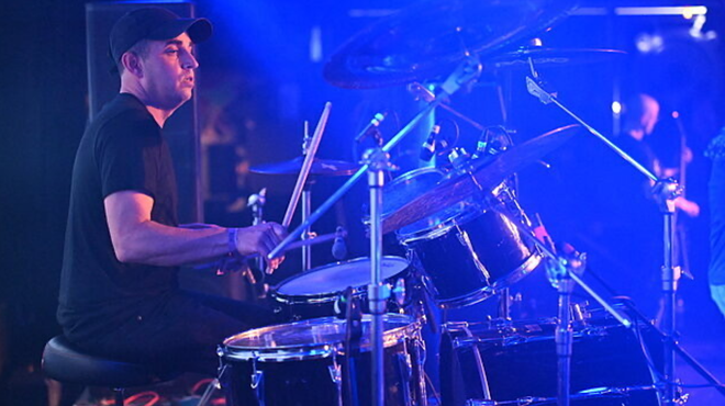 Man drumming on stage