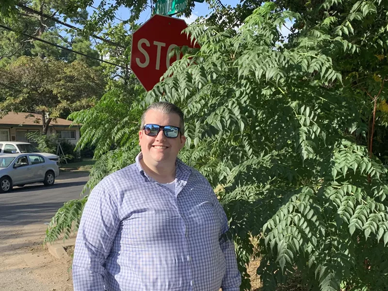 Image: Adam Sharkey, 33, submitted a service request for this stop sign near the Bonton neighborhood because it is obscured by a shrub.