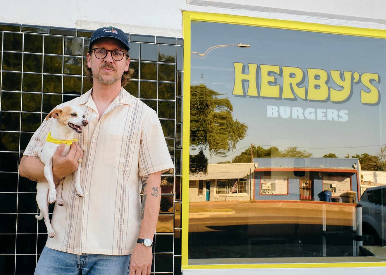 Dallas' DJ Sober poses in front of his new joint, Herby's, with OG Herby, his dog.