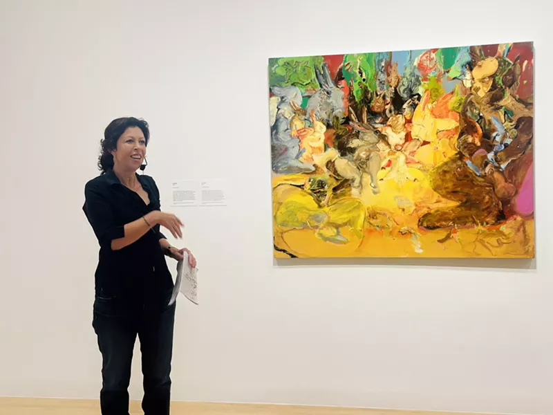 Image: Cecily Brown with one of her oil paintings, an untitled early work from 1996.