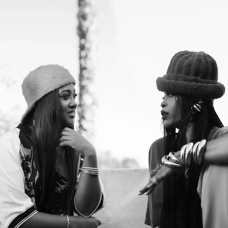 Image: Two women in conversation sitting outside