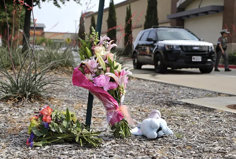Image: Flowers placed at the Allen Premium Outlets in May 2023 following a mass shooting that claimed 8 lives.