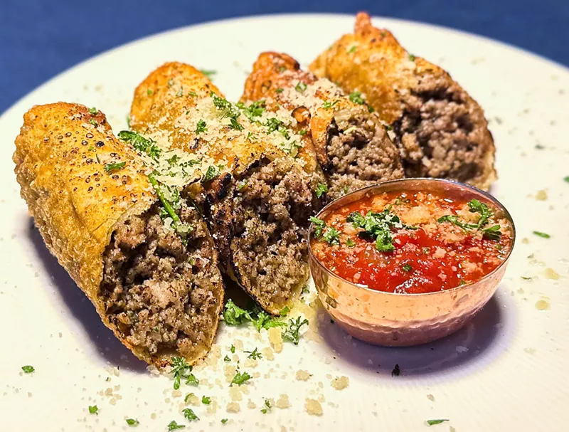 Image: Italian egg rolls: ground pork sausage, pesto and ricotta with a roasted tomato sauce.