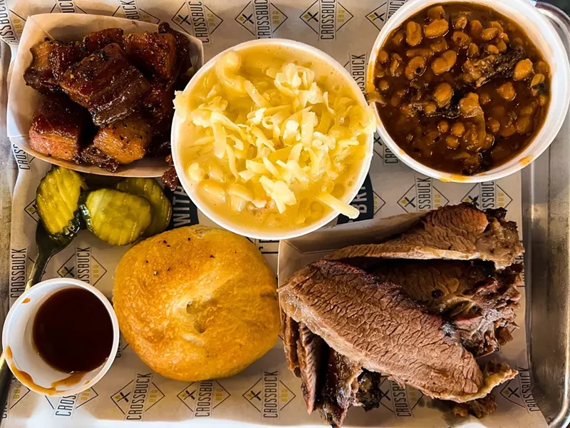 Image: Brisket, pork belly, macaroni and cheese and beans at Crossbuck BBQ