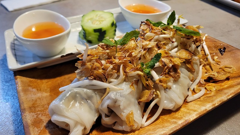 Steamed rice rolls come topped with fried shallots.