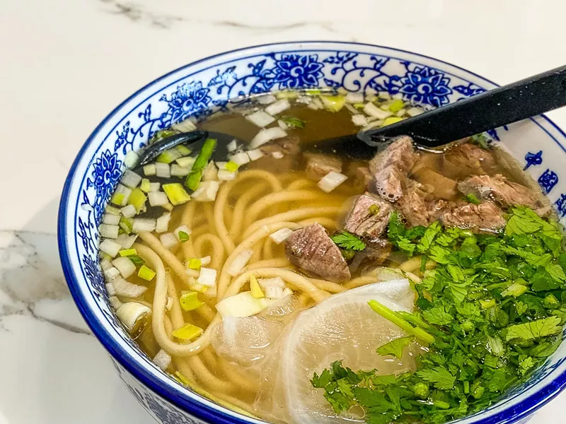 Image: Lanzhou Hand Pull Beef Noodle with cubed beef, chopped scallions and cilantro.