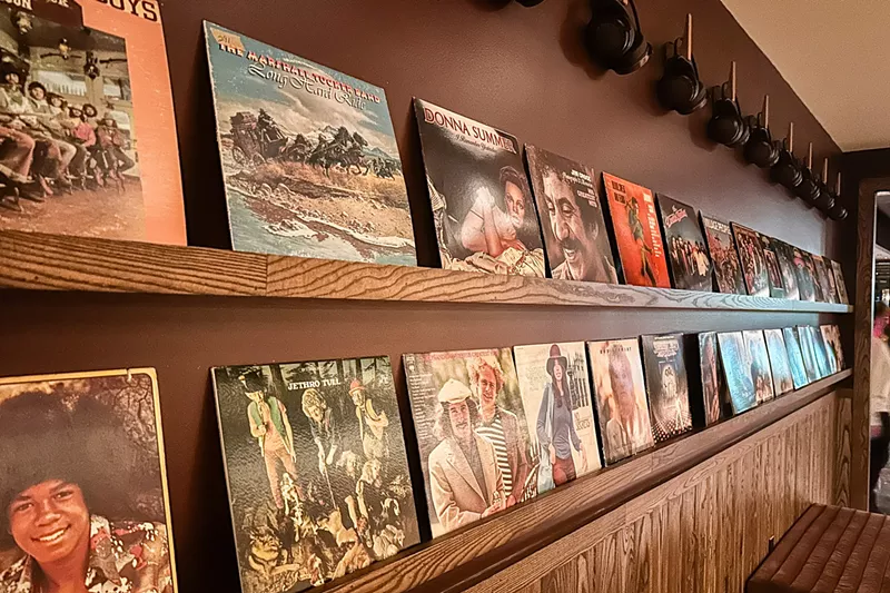 Image: Seager & Sons sets the mood with shelves and shelves of vinyl so set the 70s mood as you drink a beer or two over some pizza and fried chicken. Who are we to say no.