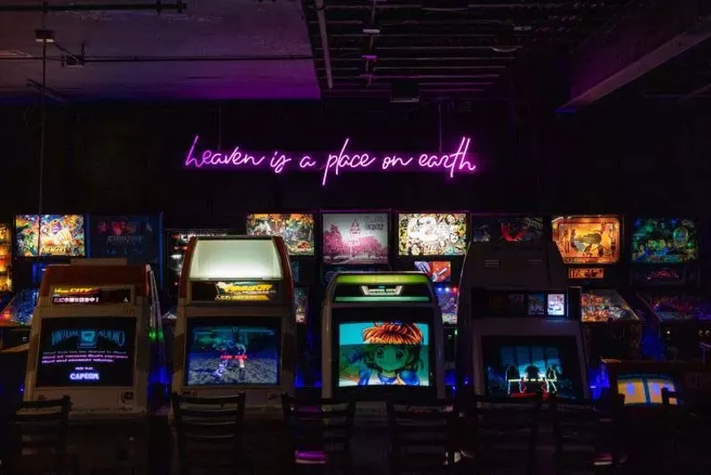 Image: The neon glow of Free Play Arcade's newest location can finally be seen on the Denton square.