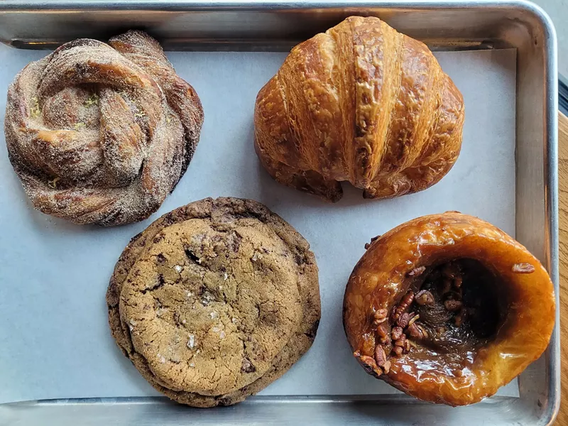 Image: These pastries at Doughregarde's include a pecan sticky bun made with croissant dough (bottom right) and a giant cookie (bottom left).