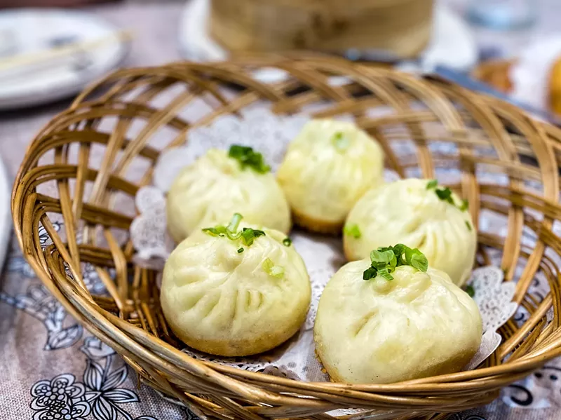 Image: The house special buns are pan fried and steamed with sesame seed bottoms and pork filling