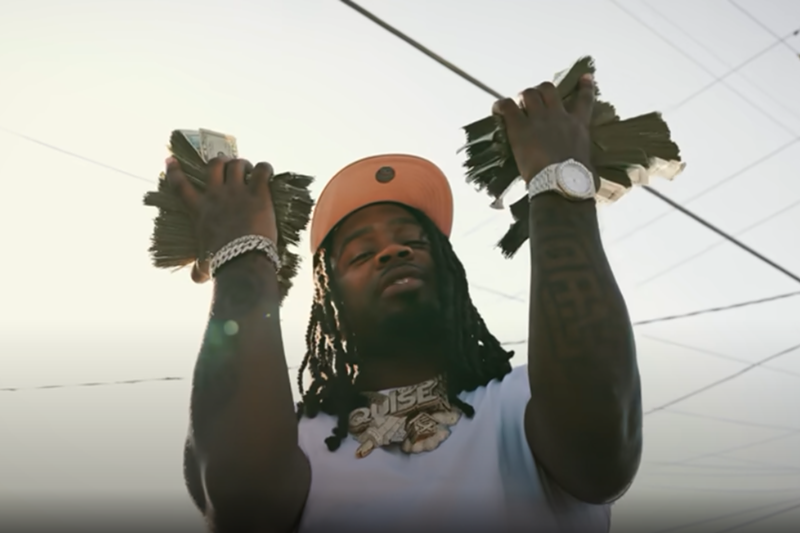 Image: Man holding wads of cash