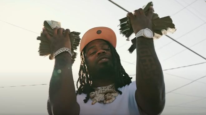 Man holding wads of cash