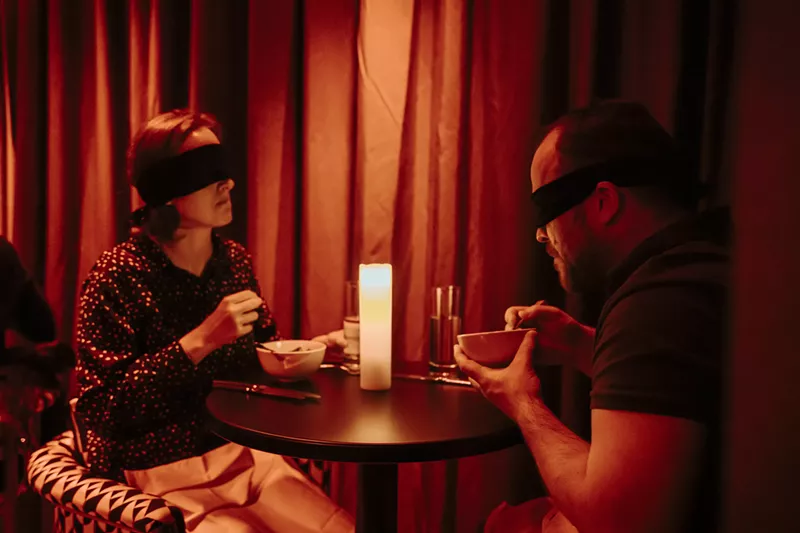 Image: Diners at Dining in the Dark have blind folds over their eyes.