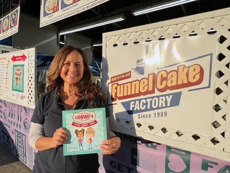 Image: Author Allyson Jannotta holds her first published book, children's story Cosmo’s Flying Funnel Cakes.