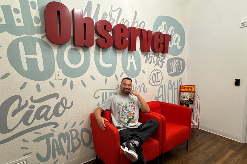 Image: Man sitting on red chair in an office
