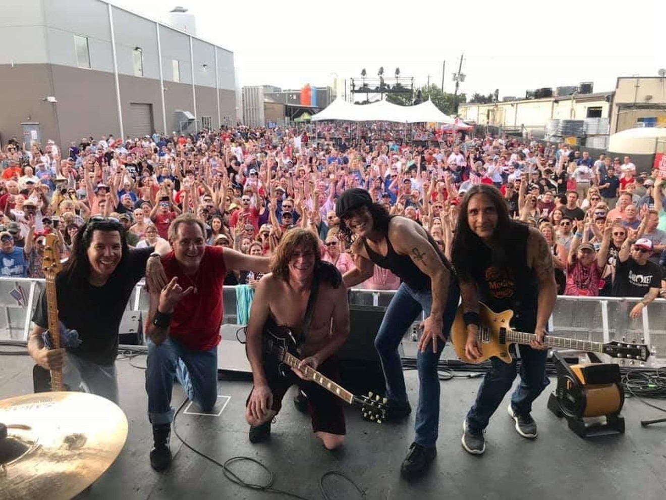 The AC/DC tribute band Back in Black including (left to right), bass player Sheldon Conrad, drummer Ken Schiumo, lead guitarist Mike Mroz, singer Darren Caperna and guitarist Ramiro Noriega, finish a set before a crowd of screaming fans at the Karbach Brewery in Houston.