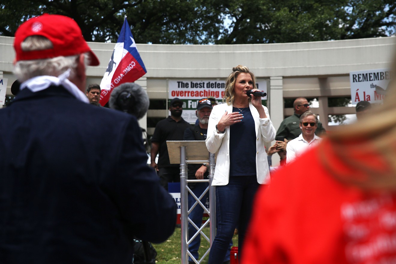 Shelley Luther, owner of Salon a la Mode, speaks at an Open Texas rally in Dealey Plaza.
