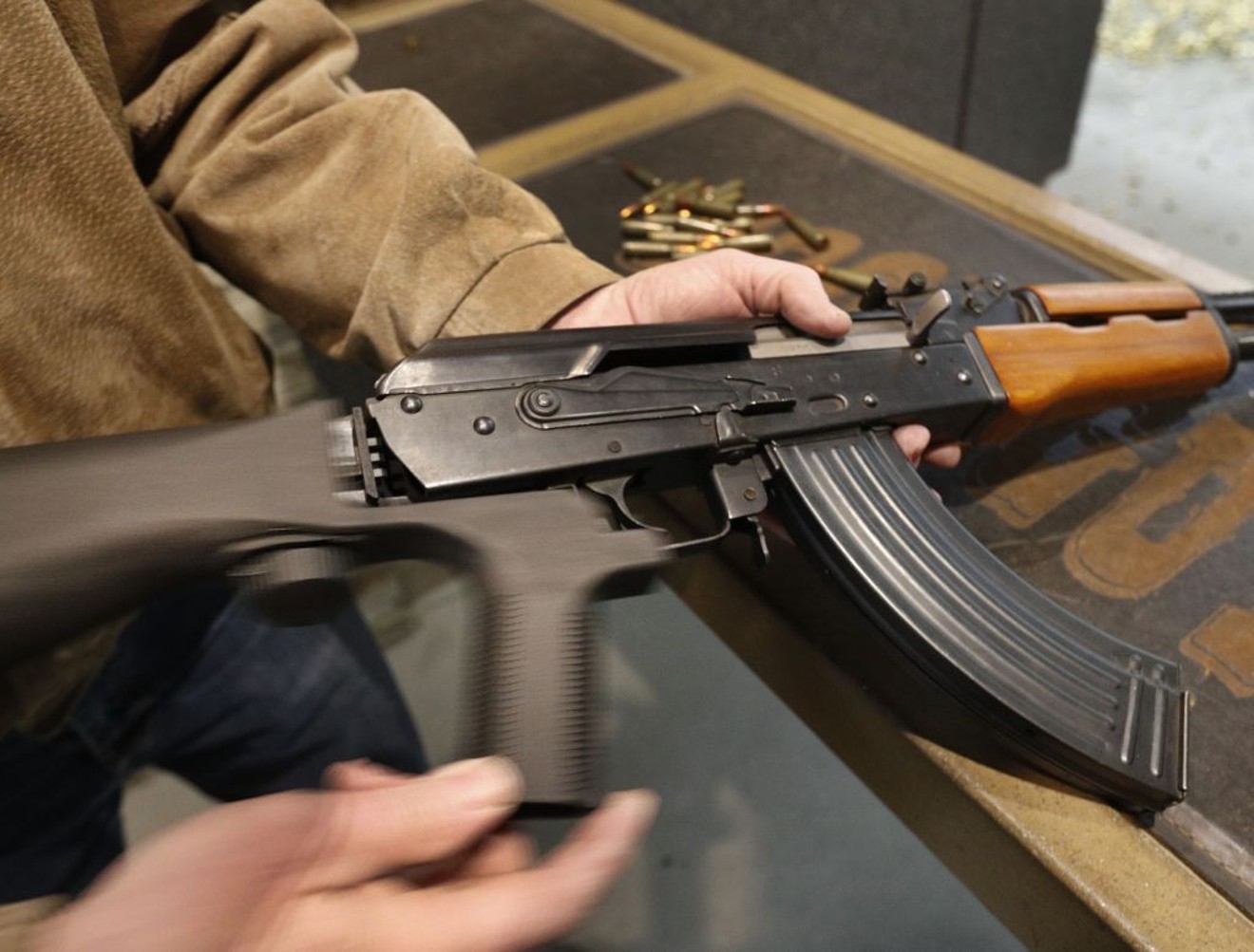 A man installs a bump stock on an AK-47 in Orem, Utah, in February 2018.