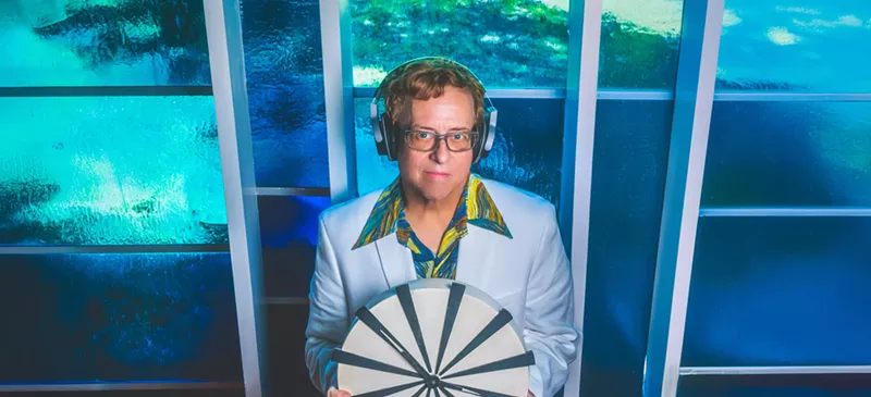 Image: Dallas DJ Mark Ridlen holds a clock.