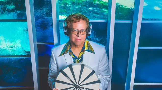 Dallas DJ Mark Ridlen holds a clock.