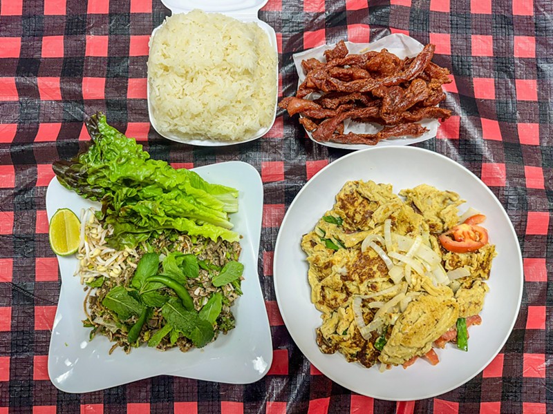 Clockwise: Sticky rice, Lao beef jerky, kau kai omelet and chicken laub.