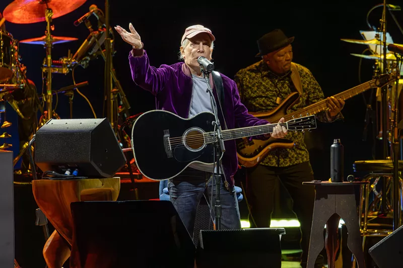 Image: Man performing on stage with a guitar