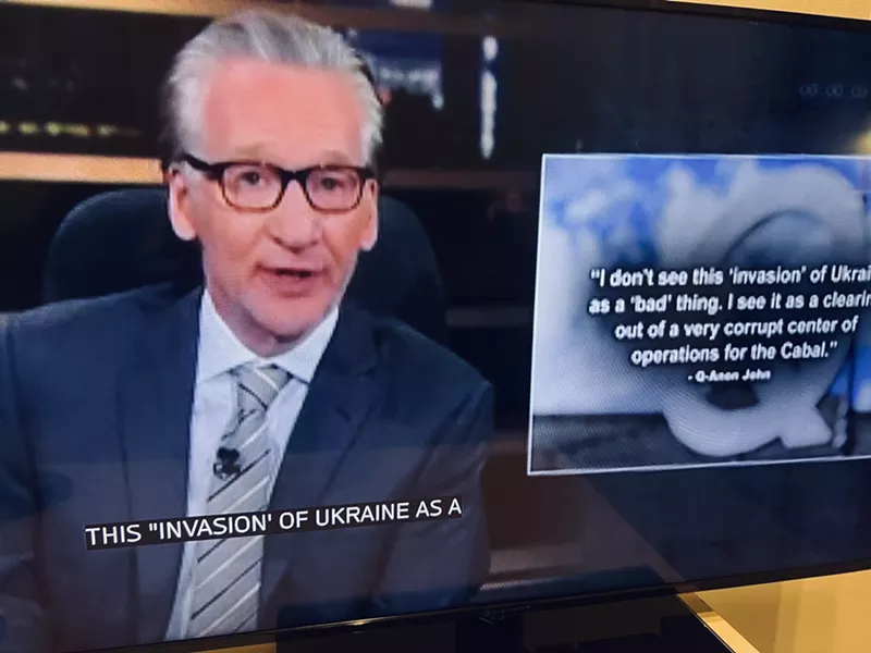 Image: Comedian and actor Bill Maher shows his Real Time audience a post by QAnon John.