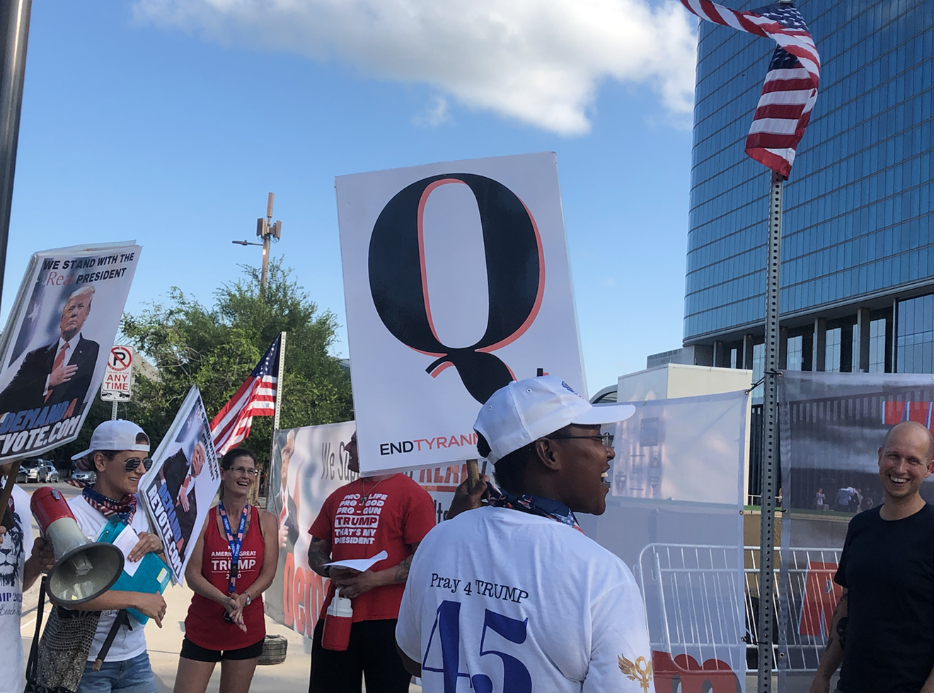 Conspiracy theory acolytes gather outside the Omni Dallas Hotel for QAnon John's Q Con over Memorial Day Weekend last year.