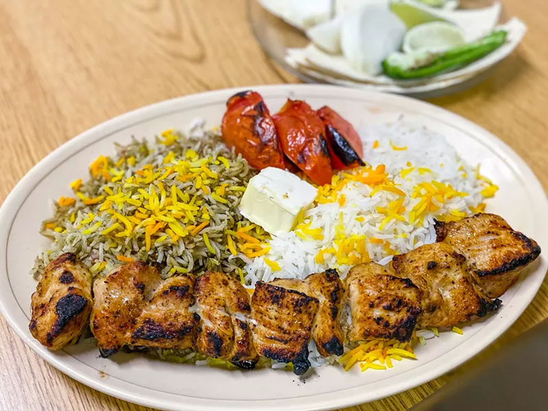 Image: joheh kabob , white meat chicken served with rice, roasted tomatoes, onions, limes, and jalapenos... and a generous pat of butter