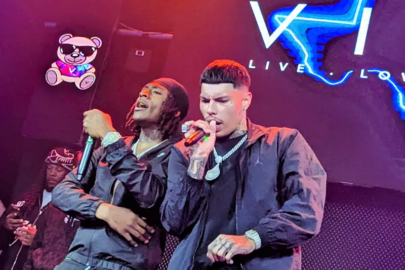 Image: Man performing with his friend on stage