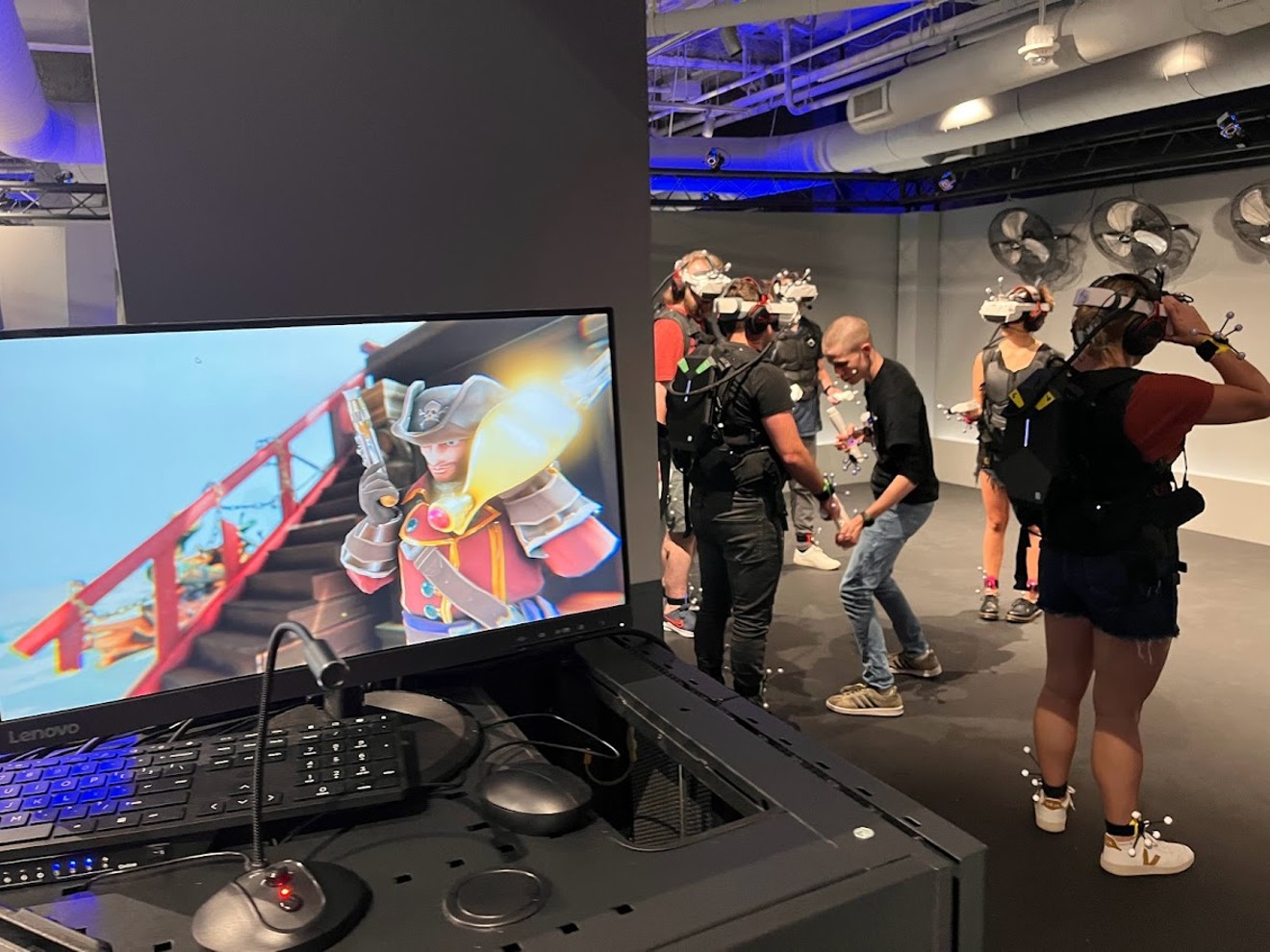 A group of players gear up for a fight with the ghost of Davy Jones in a round of Curse of Davy Jones, one of six virtual experiences at Sandbox VR in Mockingbird Station.