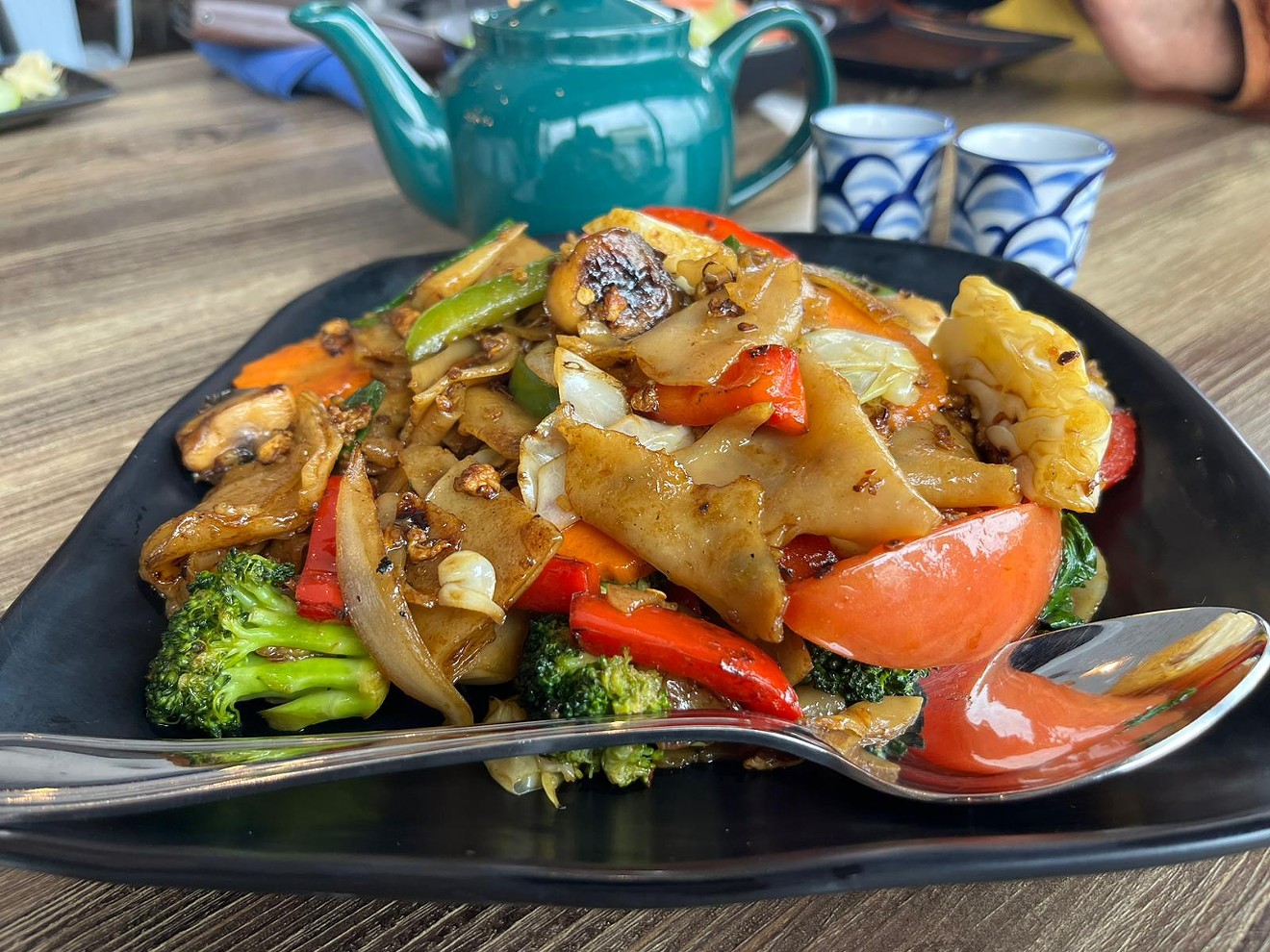 The pad kee mow dish comes drenched in a soy-based garlic sauce and your choice of protein. It's more than enough to share.
