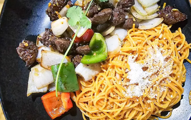 Image: The garlic noodles with shaken beef at Teaholic is one of our favorite new dishes.