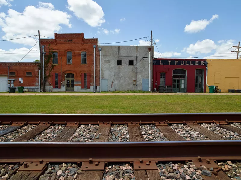 Image: Houston and Texas Central Railway crossing, Calvert. According to Mrs. Earl Turner Livingston, a woman from Bryan named Rohemia, also known as Parthens, “bought Lemon a guitar and his first suit of clothes and got him to go around playing for tenant farmers there at Calvert settlement.”