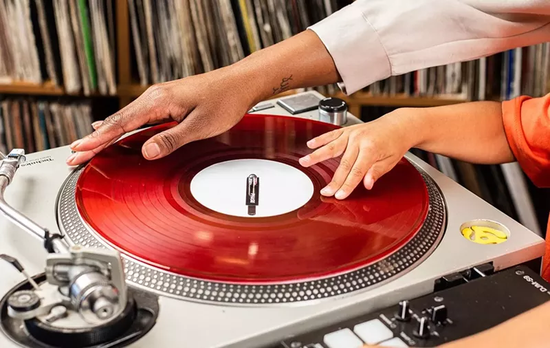 Image: DJ Christy Ray spins a record with her son, Tatum. She will be part of Dallas' official hip-hop celebration.