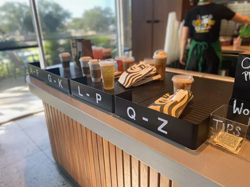 Image: Filled orders waiting to be claimed at Starbucks.