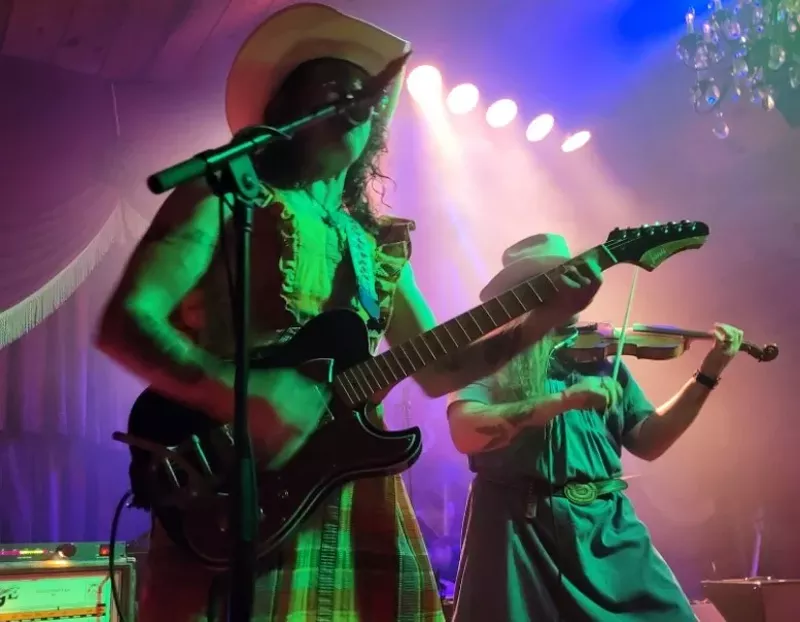 Image: Guitar player Dustin Fleming of the Vandoliers donned a dress for a show at The Shed Smokehouse & Juke Joint in Maryville, Tennessee, to protest the state's anti-drag show and anti-trans legislation.